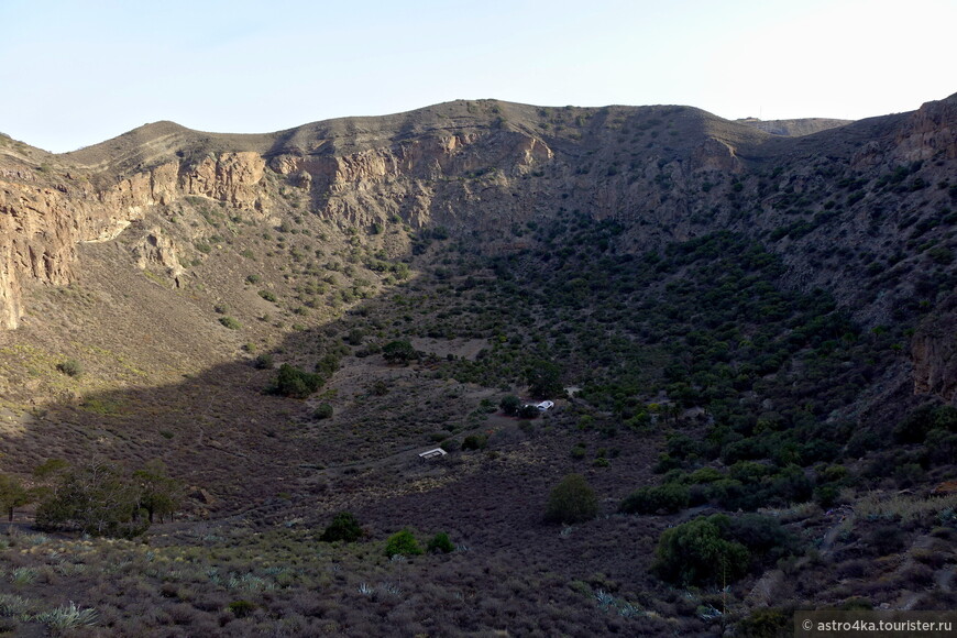Вид на кратер с середины спуска, до низа ещё очень далеко. Справа крутая серпантинная тропа.