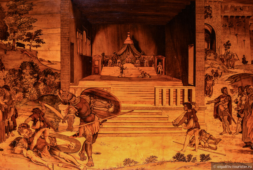 Интарсия ''Давид и Голиаф''. Если внимательно приглядеться, то можно проследить всю историю противостояния Давида. Художники шестнадцатого века часто изображали последовательность действий на одной картине.
