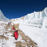 Porter carrying loads to Everest base camp trek.