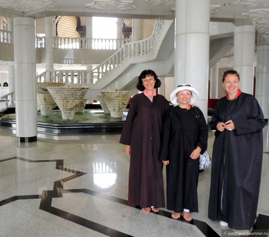 Только так нужно быть одетыми в мечети женщинам. Позади видны пять чаш с фонтанами, имеющими свой сакральный смысл